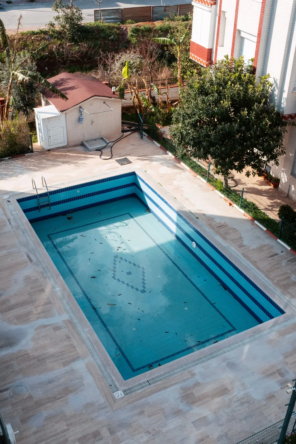 Drained outdoor pool with the interior surface exposed